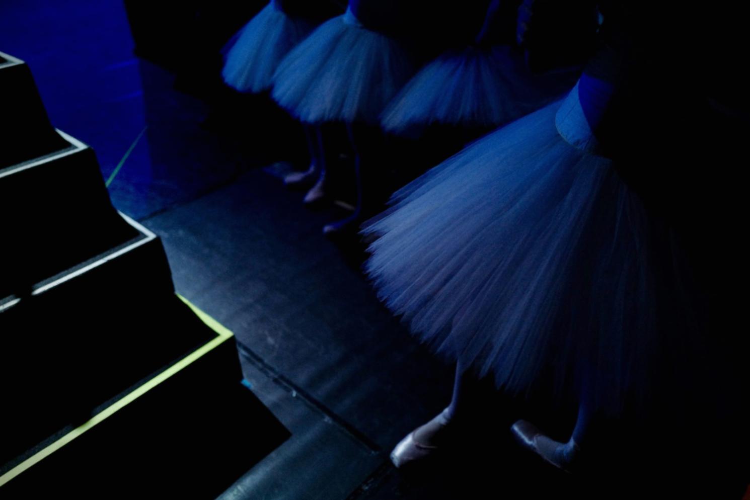 Tap dancer performing on stage with spotlight